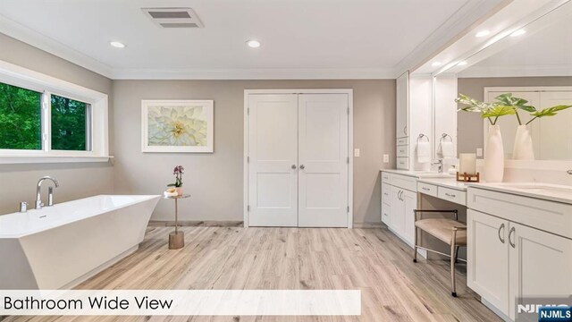 108 Buckhaven Hl, Upper Saddle River, NJ 07458 - full bath with vanity, crown molding, wood finished floors, a freestanding bath, and recessed lighting