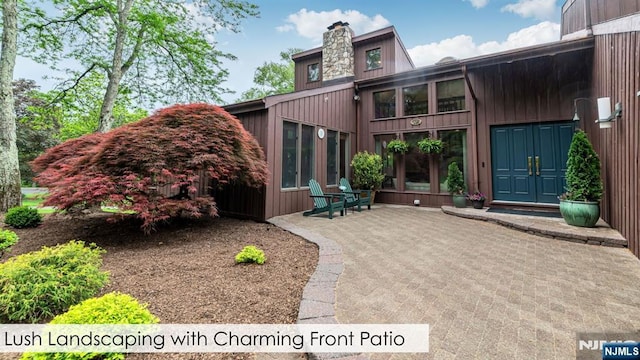 108 Buckhaven Hl, Upper Saddle River, NJ 07458 - view of exterior entry with a chimney