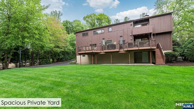 108 Buckhaven Hl, Upper Saddle River, NJ 07458 - rear view of house with a lawn, a deck, and stairs