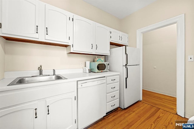 1055 Boulevard Blvd Unit D3, Weehawken, NJ 07086 - kitchen featuring white appliances, a sink, white cabinets, light wood finished floors, and light countertops