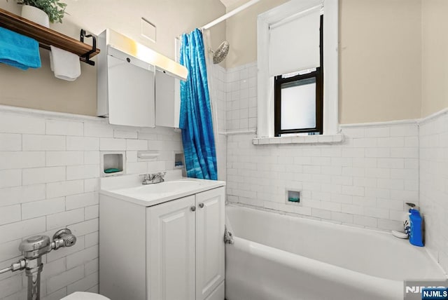 1055 Boulevard Blvd Unit D3, Weehawken, NJ 07086 - full bathroom with tile walls, vanity, shower / tub combo with curtain, and a wainscoted wall