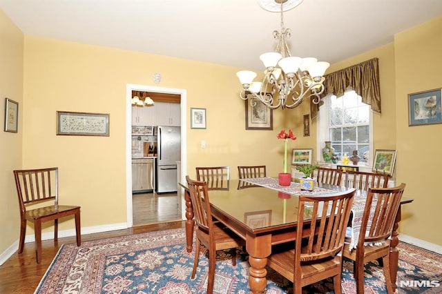 927 Commonwealth Dr Unit 4, Teaneck, NJ 07666 - dining space featuring a chandelier, wood finished floors, and baseboards