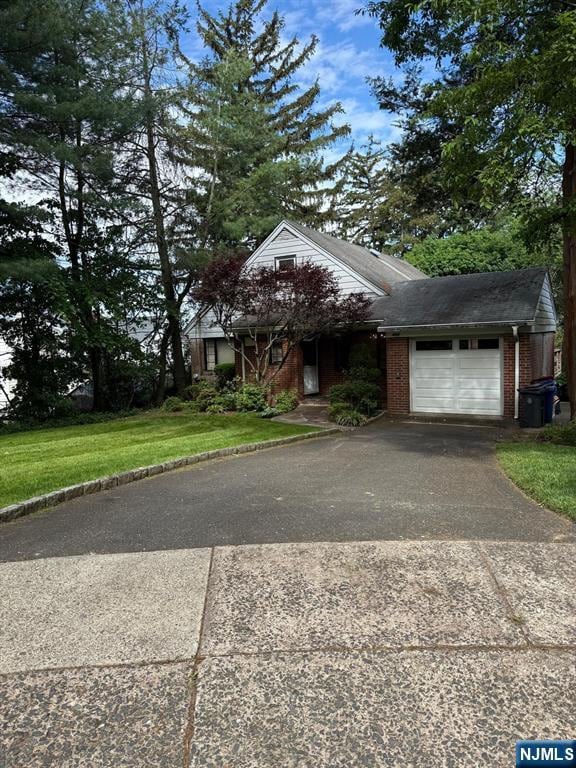 384 Audubon Rd, Englewood, NJ 07631 - view of front of home featuring driveway, a garage, and brick siding