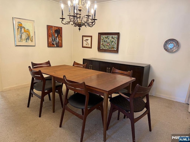 384 Audubon Rd, Englewood, NJ 07631 - dining room featuring light colored carpet, a chandelier, baseboards, and ornamental molding