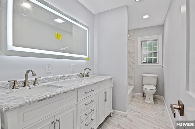 bathroom with marble look tiles, double vanity, baseboards, toilet, and recessed lighting