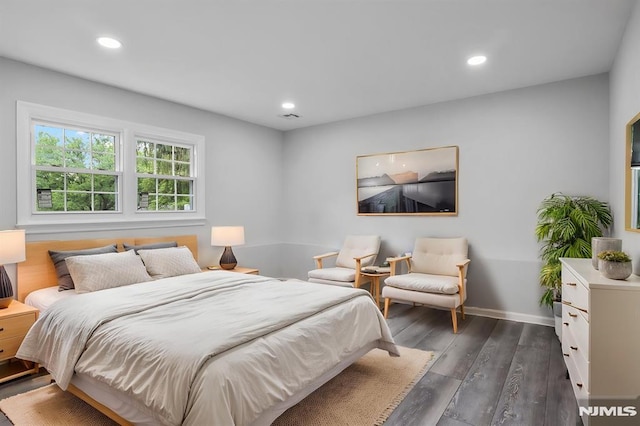 bedroom with dark wood finished floors, recessed lighting, and baseboards