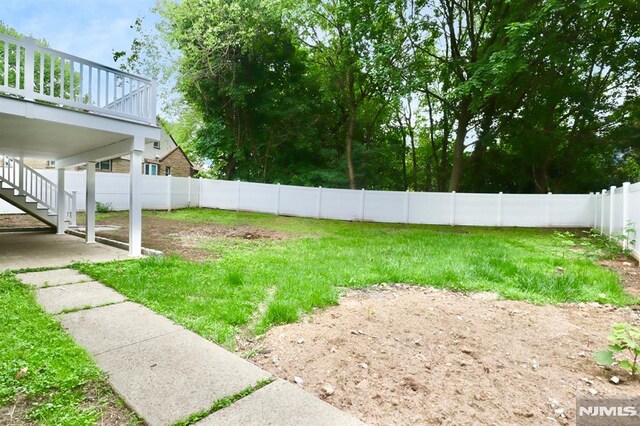 view of yard featuring a patio and stairs