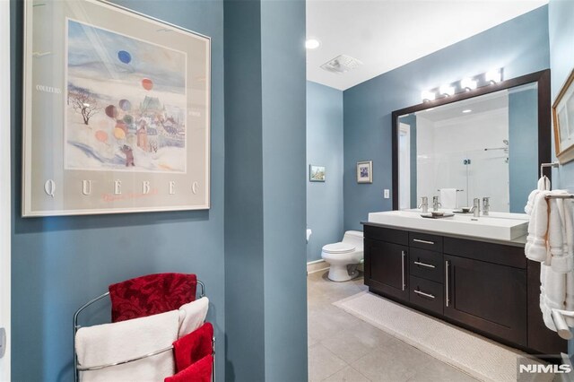 8709 Churchill Rd, North Bergen, NJ 07047 - bathroom featuring toilet, double vanity, and tile patterned flooring