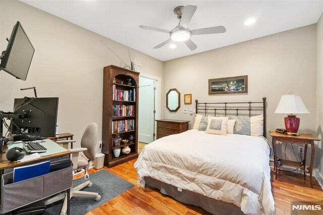 8709 Churchill Rd, North Bergen, NJ 07047 - bedroom featuring light wood-style flooring, an office area, recessed lighting, and ceiling fan