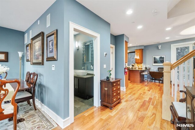 8709 Churchill Rd, North Bergen, NJ 07047 - office area with light wood-type flooring, baseboards, recessed lighting, and a sink