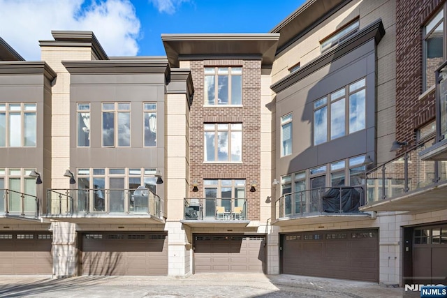 1 Oxford Lndg Unit 1, Weehawken, NJ 07086 - view of building exterior featuring an attached garage and driveway