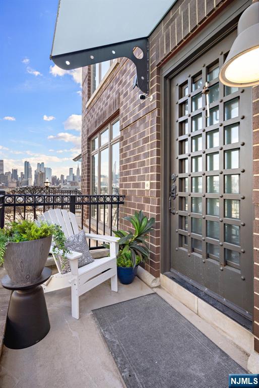 1 Oxford Lndg Unit 1, Weehawken, NJ 07086 - view of exterior entry with brick siding and a skyline view