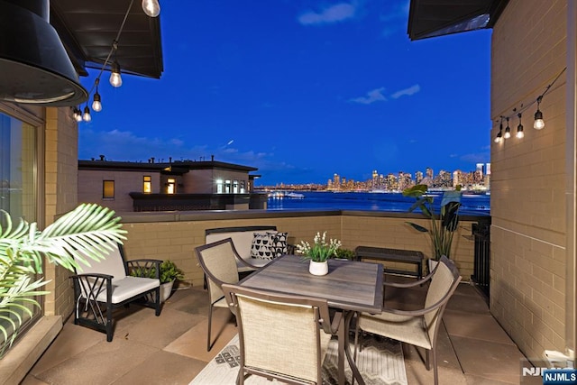 1 Oxford Lndg Unit 1, Weehawken, NJ 07086 - patio at night with outdoor dining space and a water view