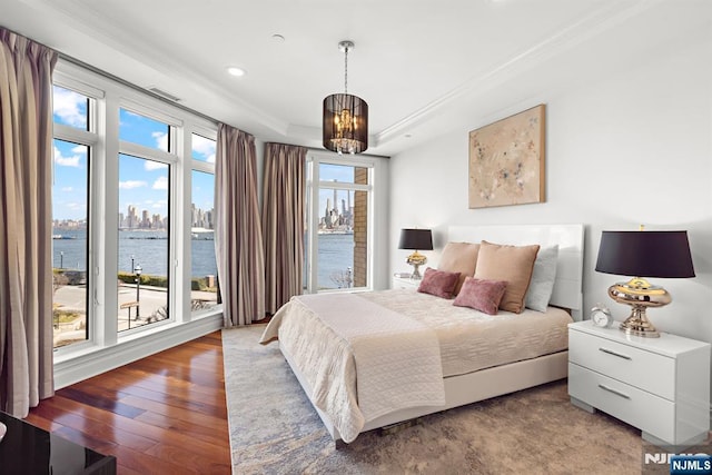 1 Oxford Lndg Unit 1, Weehawken, NJ 07086 - bedroom featuring a water view, ornamental molding, wood-type flooring, a tray ceiling, and recessed lighting