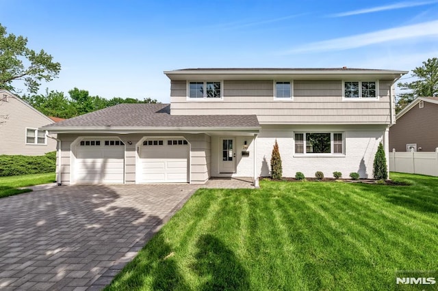 246 Oakwood Dr, Paramus, NJ 07652 - view of front of home with an attached garage and decorative driveway