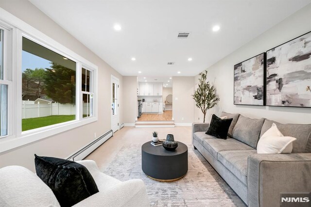 246 Oakwood Dr, Paramus, NJ 07652 - living room with a baseboard heating unit, recessed lighting, plenty of natural light, and light carpet