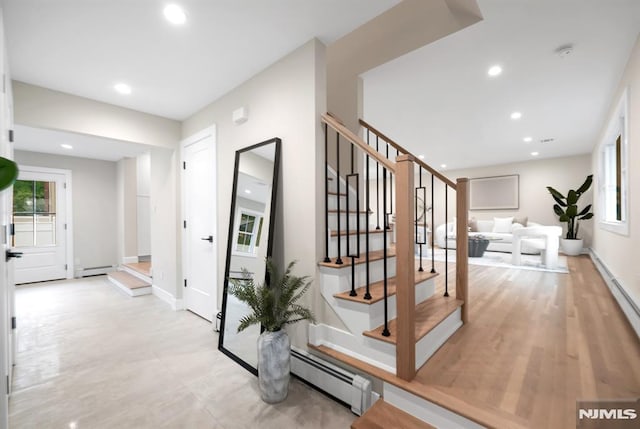 246 Oakwood Dr, Paramus, NJ 07652 - hallway featuring baseboard heating, plenty of natural light, stairway, and recessed lighting