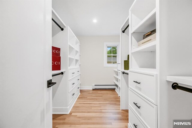 246 Oakwood Dr, Paramus, NJ 07652 - spacious closet with a baseboard heating unit and light wood-style flooring