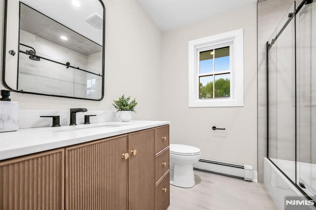 246 Oakwood Dr, Paramus, NJ 07652 - full bathroom with a baseboard radiator, toilet, vanity, and enclosed tub / shower combo
