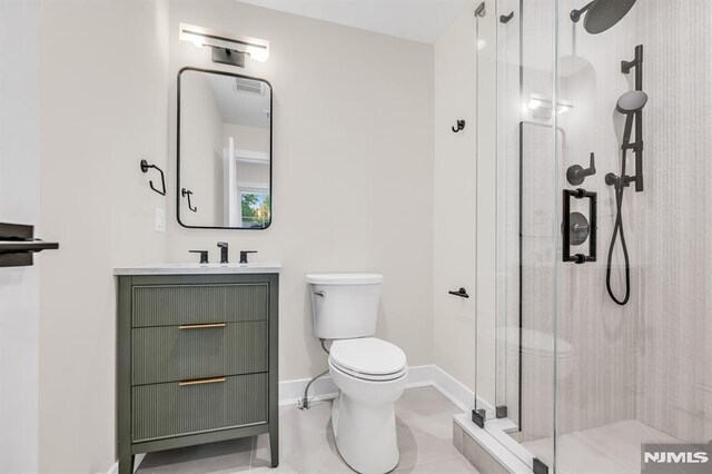 246 Oakwood Dr, Paramus, NJ 07652 - full bath featuring a stall shower, toilet, baseboards, vanity, and tile patterned floors