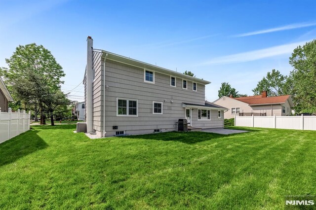 246 Oakwood Dr, Paramus, NJ 07652 - back of property with a chimney, a patio area, and cooling unit
