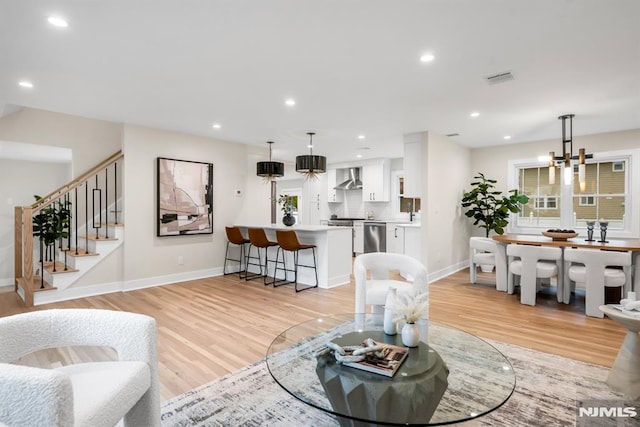 246 Oakwood Dr, Paramus, NJ 07652 - living area with light wood-type flooring, baseboards, recessed lighting, and stairs