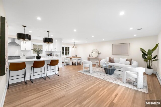 246 Oakwood Dr, Paramus, NJ 07652 - living area featuring light wood finished floors, recessed lighting, and baseboards