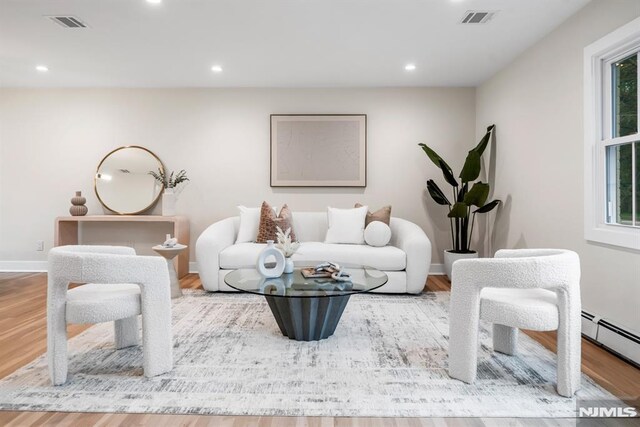 246 Oakwood Dr, Paramus, NJ 07652 - living area featuring wood finished floors, recessed lighting, baseboards, and a baseboard radiator