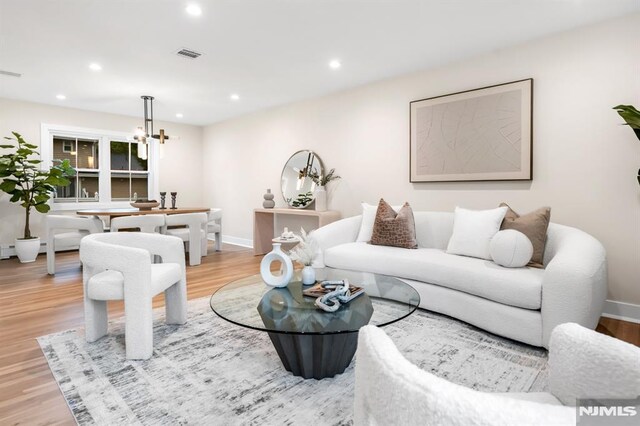 246 Oakwood Dr, Paramus, NJ 07652 - living room featuring a chandelier, wood finished floors, recessed lighting, and baseboards