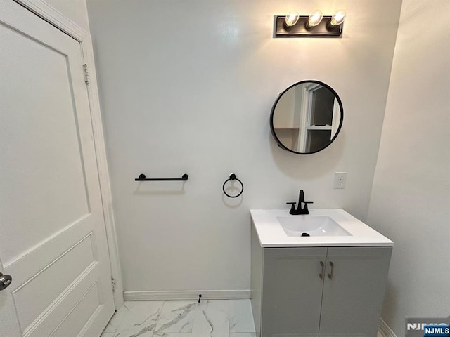 257 New St, Orange, NJ 07050 - bathroom with marble finish floors, baseboards, and vanity