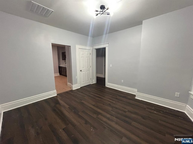 257 New St, Orange, NJ 07050 - empty room featuring dark wood-style floors, baseboards, and a chandelier