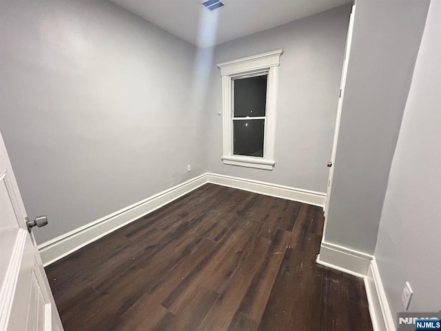 257 New St, Orange, NJ 07050 - spare room featuring dark wood-style flooring and baseboards