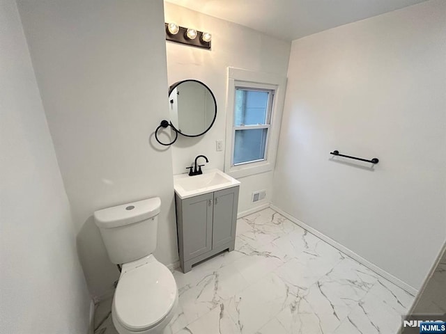 257 New St, Orange, NJ 07050 - bathroom featuring marble look tile flooring, toilet, and baseboards