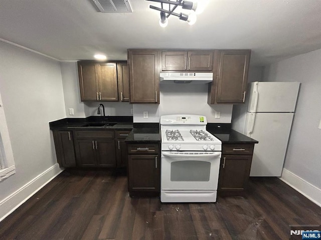 257 New St, Orange, NJ 07050 - kitchen featuring white appliances, a sink, baseboards, and dark countertops
