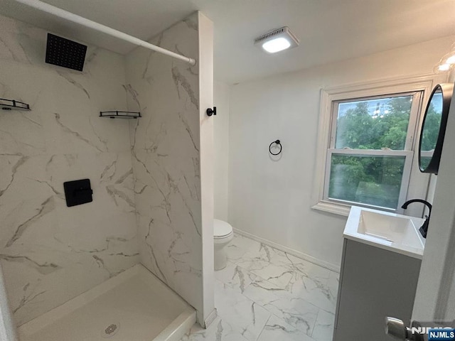 257 New St, Orange, NJ 07050 - full bathroom featuring marble look tile flooring, a marble finish shower, vanity, toilet, and baseboards
