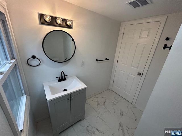 257 New St, Orange, NJ 07050 - bathroom with vanity, marble finish flooring, and baseboards