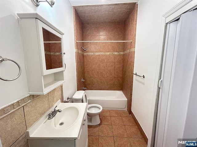 257 New St, Orange, NJ 07050 - bathroom featuring toilet, vanity,  shower combination, and tile patterned floors