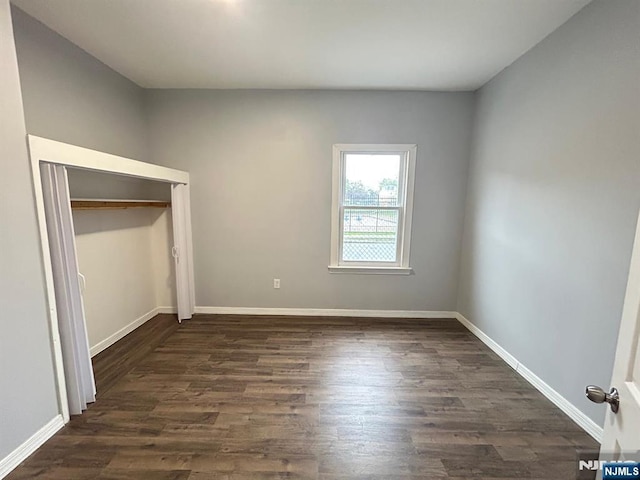 257 New St, Orange, NJ 07050 - unfurnished bedroom featuring dark wood-style flooring, a closet, and baseboards