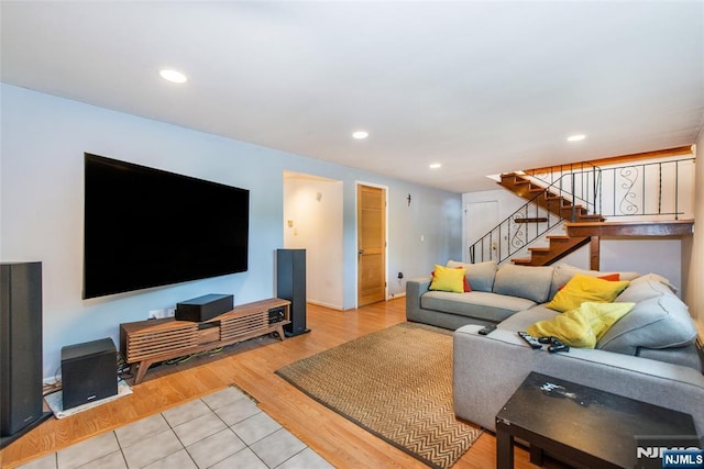 living area with stairs, recessed lighting, wood finished floors, and baseboards