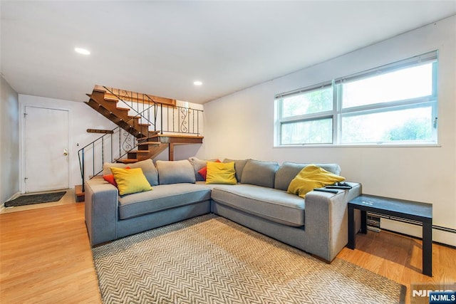 living room with light wood finished floors, stairway, and recessed lighting