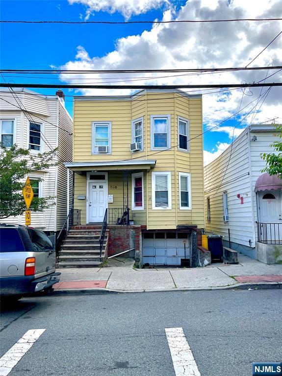398 Cliff St, Fairview, NJ 07022 - townhome / multi-family property with a garage and cooling unit