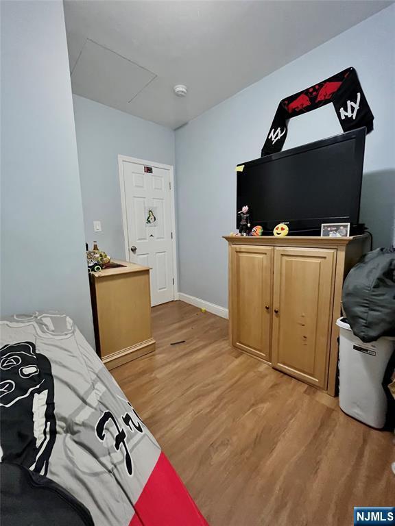 398 Cliff St, Fairview, NJ 07022 - bedroom featuring light wood-style flooring and baseboards