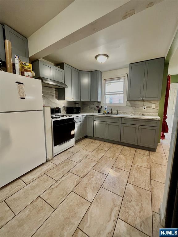 398 Cliff St, Fairview, NJ 07022 - kitchen with white appliances, gray cabinetry, light countertops, and a sink