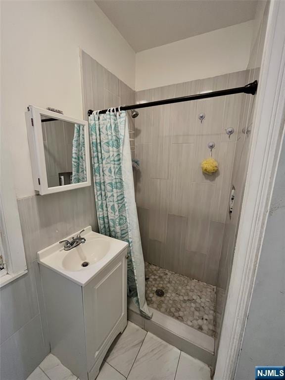 398 Cliff St, Fairview, NJ 07022 - full bath featuring vanity, a shower stall, and marble look tiles