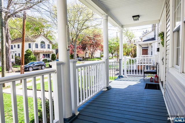 238 Milford Ave, New Milford, NJ 07646 - wooden terrace with covered porch and a residential view