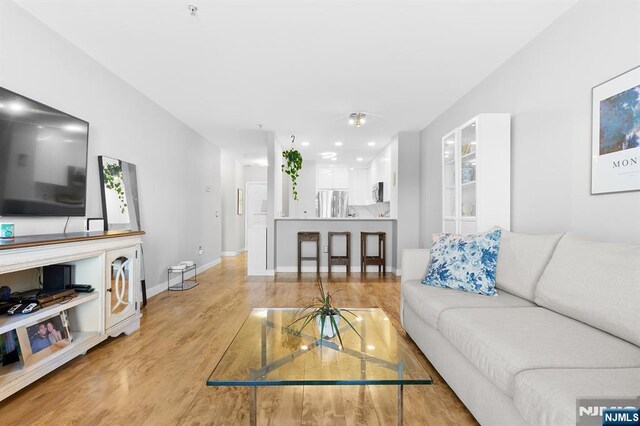 154 The Promenade, Edgewater, NJ 07020 - living area with light wood-style flooring and baseboards