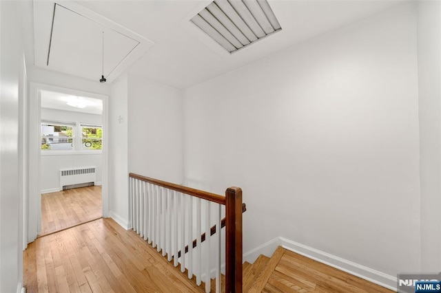 7 Edgewater Pl, Edgewater, NJ 07020 - corridor featuring attic access, radiator heating unit, an upstairs landing, light wood finished floors, and baseboards