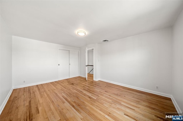 7 Edgewater Pl, Edgewater, NJ 07020 - unfurnished bedroom with light wood-type flooring, baseboards, and a closet