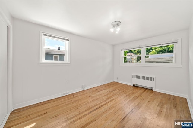 7 Edgewater Pl, Edgewater, NJ 07020 - empty room featuring radiator, light wood finished floors, and baseboards