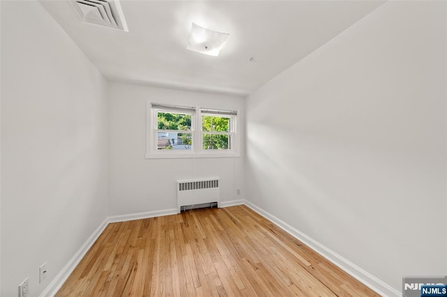 7 Edgewater Pl, Edgewater, NJ 07020 - unfurnished room featuring radiator heating unit, light wood-style floors, and baseboards